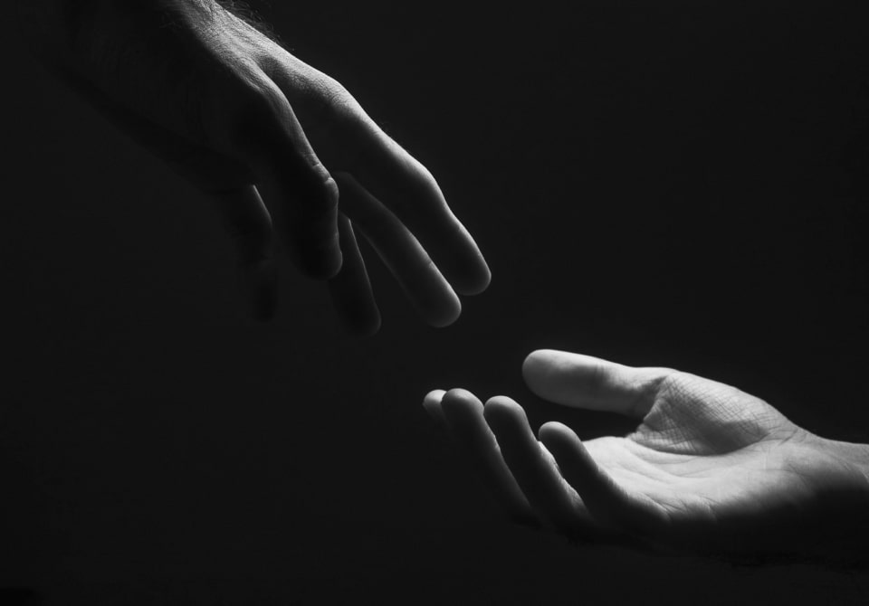 Two hands touch each other.